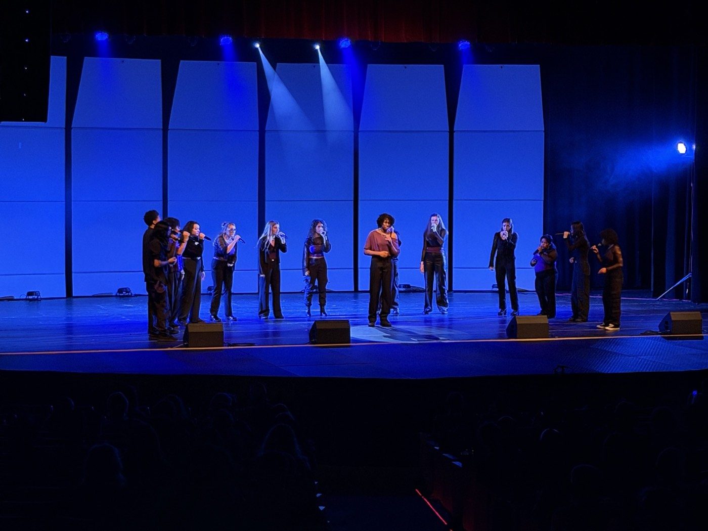aChoired Harmony on stage, blue lights